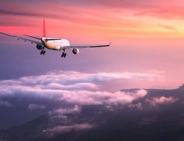 airplane flying at sunset